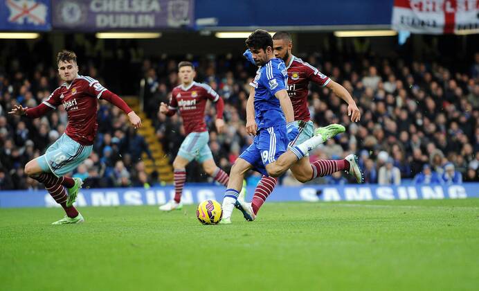 Diego Costa of Chelsea scores his goal to make it to make it 2-0 - Barclays Premier League - Chelsea vs West Ham United - Stamford Bridge Stadium - London - England - 26th December 2014 - Pic Robin Parker Sportimage EDITORIAL USE ONLY. No use with unauthorised audio, video, data, fixture lists, club league logos or live services. Online in-match use limited to 120 images, no video emulation. No use in betting, games or single club league player publications. DSC_3037