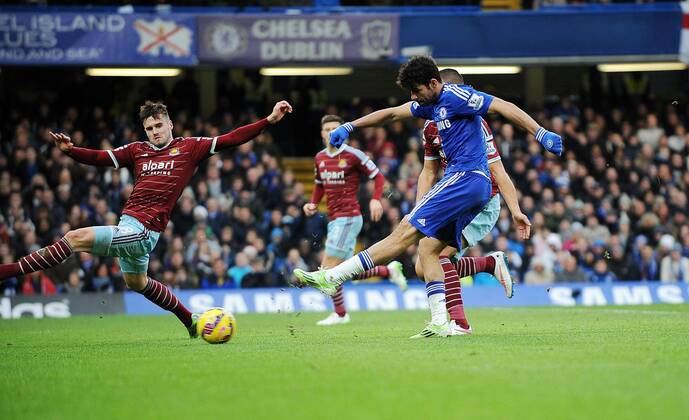 Diego Costa of Chelsea scores his goal to make it to make it 2-0 - Barclays Premier League - Chelsea vs West Ham United - Stamford Bridge Stadium - London - England - 26th December 2014 - Pic Robin Parker Sportimage EDITORIAL USE ONLY. No use with unauthorised audio, video, data, fixture lists, club league logos or live services. Online in-match use limited to 120 images, no video emulation. No use in betting, games or single club league player publications. DSC_3038