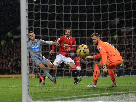 Manchester United ManU s Robin Van Persie scoring his sides third goal Barclays Premier League - Manchester United vs Newcastle United - Old Trafford - England - 26th December 2014 - Picture David Klein Sportimage EDITORIAL USE ONLY. No use with unauthorised audio, video, data, fixture lists, club league logos or live services. Online in-match use limited to 120 images, no video emulation. No use in betting, games or single club league player publications.
