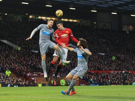 Manchester United ManU s Robin van Persie tussles with Newcastle s Paul Dummett Barclays Premier League - Manchester United vs Newcastle United - Old Trafford - England - 26th December 2014 - Picture David Klein Sportimage EDITORIAL USE ONLY. No use with unauthorised audio, video, data, fixture lists, club league logos or live services. Online in-match use limited to 120 images, no video emulation. No use in betting, games or single club league player publications.