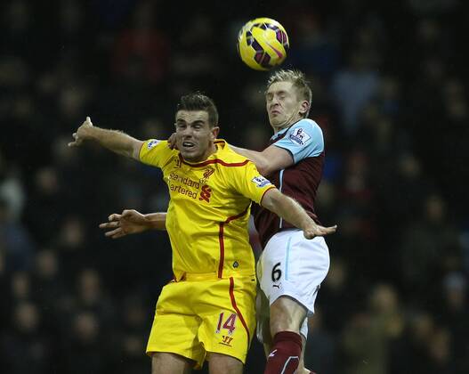 Jordan Henderson of Liverpool tussles with Ben Mee of Burnley - Barclays Premier League - FC Burnley - FC Liverpool - Turf Moor Stadium - Burnley - England - 26th December 2014 - Picture Simon Bellis Sportimage EDITORIAL USE ONLY. No use with unauthorised audio, video, data, fixture lists, club league logos or live services. Online in-match use limited to 120 images, no video emulation. No use in betting, games or single club league player publications.
