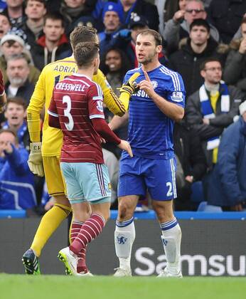 Football - 2014 2015 Premier League - Chelsea vs. West Ham United Chelsea s Branislav Ivanovic is challenged by West ham players, accusing him of diving at Stamford Bridge. COLORSPORT ANDREW COWIE