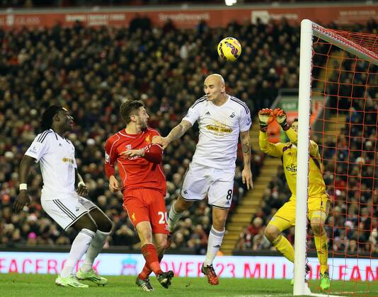 Jonjo Shelvey of Swansea City gets a touch to score an own goal - Barclays Premier League - Liverpool vs Swansea City - Anfield Stadium - Liverpool - England - 29th December 2014 - Picture Simon Bellis Sportimage EDITORIAL USE ONLY. No use with unauthorised audio, video, data, fixture lists, club league logos or live services. Online in-match use limited to 120 images, no video emulation. No use in betting, games or single club league player publications.