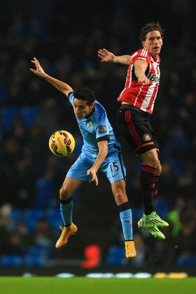 Jesus Navas of Manchester City and Billy Jones of Sunderland contest a header - Manchester City vs. Sunderland - Barclay s Premier League - Etihad Stadium - Manchester - 28 12 2014 Pic Philip Oldham Sportimage EDITORIAL USE ONLY. No use with unauthorised audio, video, data, fixture lists, club league logos or live services. Online in-match use limited to 120 images, no video emulation. No use in betting, games or single club league player publications.