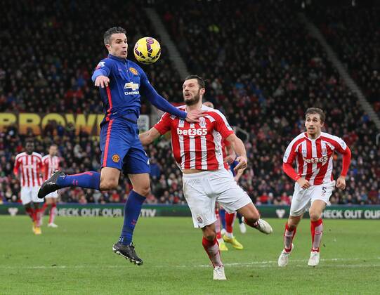 Robin van Persie of Manchester United ManU controls the ball midair as Geoff Cameron of Stoke City comes in - Barclays Premier League - Stoke City vs Manchester Utd - Stoke - England - 1st January 2015 - Picture Simon Bellis Sportimage EDITORIAL USE ONLY. No use with unauthorised audio, video, data, fixture lists, club league logos or live services. Online in-match use limited to 120 images, no video emulation. No use in betting, games or single club league player publications.