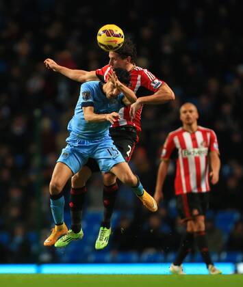 Jesus Navas of Manchester City and Billy Jones of Sunderland contest a header - Manchester City vs. Sunderland - Barclay s Premier League - Etihad Stadium - Manchester - 28 12 2014 Pic Philip Oldham Sportimage EDITORIAL USE ONLY. No use with unauthorised audio, video, data, fixture lists, club league logos or live services. Online in-match use limited to 120 images, no video emulation. No use in betting, games or single club league player publications.