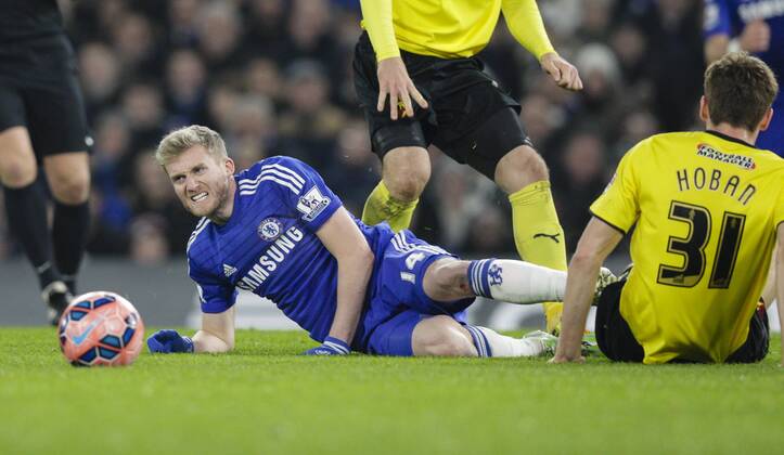 04.01.2015. Stamford Bridge, London, England. FA Cup 3rd Round. Chelsea versus Watford. Chelsea s Andre Schurrle grimaces after a heavy challenge from Watford s Tommie Hoban xCraigxMercerx  ActionPlus11586897