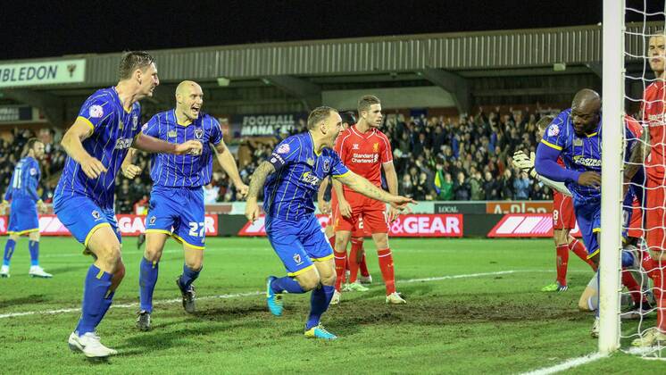 Aktuell Fußball, England, FA Cup, AFC Wimbledon - FC Liverpool Football - 2014 2015 FA Cup - Third Round: AFC Wimbledon - FC Liverpool, AFC Wimbledon s Adebayo Akinfenwa turns away in celebration after scoring the equalising goal at The Cherry Red Records Stadium WIM_LIV