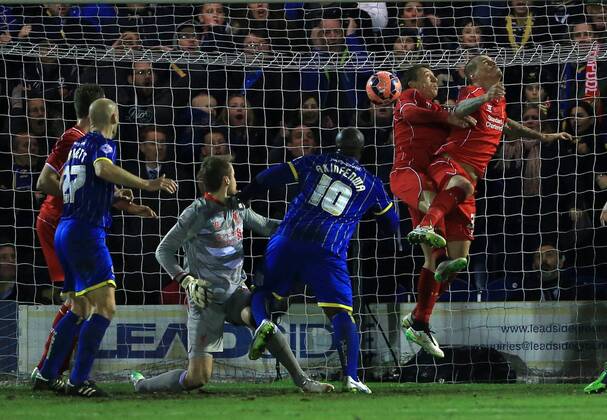 Aktuell Fußball, England, FA Cup, AFC Wimbledon - FC Liverpool Liverpool s Lucas Leiva and Martin Skrtel fail to clear to gift AFC Wimbledon their opening goal FA Cup Third Round - AFC Wimbledon - FC Liverpool - Kingsmeadow Stadium park - England - 5th January 2015 - EDITORIAL USE ONLY. No use with unauthorised audio, video, data, fixture lists, club league logos or live services. Online in-match use limited to 120 images, no video emulation. No use in betting, games or single club league player publications.