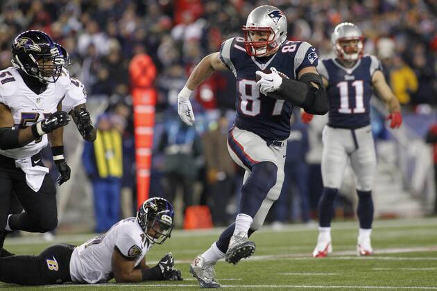 New England Patriots tight end Rob Gronkowski (87) doges a tackle by Baltimore Ravens cornerback Anthony Levine (41) and linebacker Daryl Smith (51) on a 23-yard reception in the second quarter of the AFC Divisional Playoff game at Gillette Stadium in Foxborough, Massachusetts on January 10, 2015. The Patriots defeated the Ravens 35-31. Photo by Matthew Healey UPI  BOS2015011012 MATTHEWxHEALEY