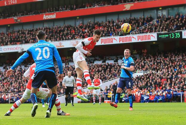Arsenal s Laurent Koscielny scoring his sides opening goal Premier League - Arsenal vs Stoke City - Emirates Stadium - England - 11th January 2015 - Picture David Klein Sportimage EDITORIAL USE ONLY. No use with unauthorised audio, video, data, fixture lists, club league logos or live services. Online in-match use limited to 120 images, no video emulation. No use in betting, games or single club league player publications.