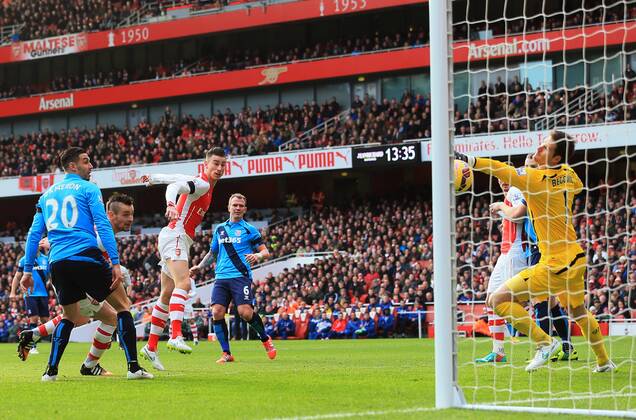 Arsenal s Laurent Koscielny scoring his sides opening goal Premier League - Arsenal vs Stoke City - Emirates Stadium - England - 11th January 2015 - Picture David Klein Sportimage EDITORIAL USE ONLY. No use with unauthorised audio, video, data, fixture lists, club league logos or live services. Online in-match use limited to 120 images, no video emulation. No use in betting, games or single club league player publications.