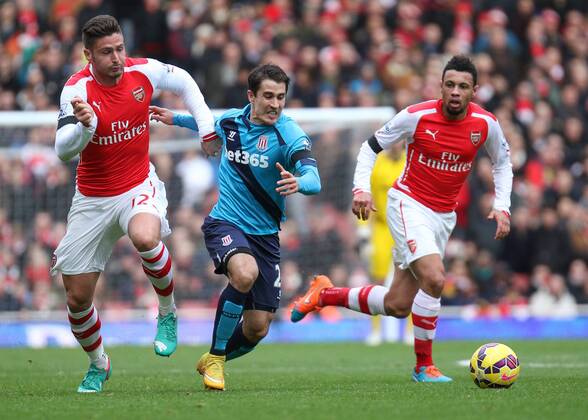 Football - 2014 2015 - Barclays Premier League, - Arsenal Vs Stoke City, Stoke City s Bojan Krkic is held back by Arsenal s Olivier Giroud at The Emirates Stadium COLORSPORT DANIEL BEARHAM ARS_STO