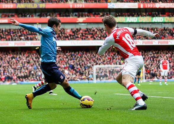 Football - 2014 2015 - Barclays Premier League, - Arsenal Vs Stoke City, Stoke City s Bojan Krkic cuts inside Arsenal s Nacho Monreal at The Emirates Stadium COLORSPORT DANIEL BEARHAM ARS_STO