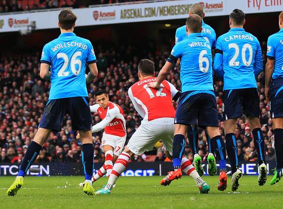 Arsenal s Alexis Sanchez scoring his sides third goal Premier League - Arsenal vs Stoke City - Emirates Stadium - England - 11th January 2015 - Picture David Klein Sportimage EDITORIAL USE ONLY. No use with unauthorised audio, video, data, fixture lists, club league logos or live services. Online in-match use limited to 120 images, no video emulation. No use in betting, games or single club league player publications.