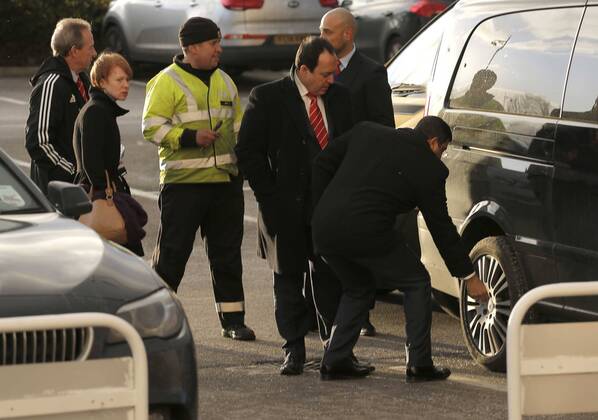 Nottingham Forest chairman Fawaz Al Hasawi i(centre) inspects damage to his car following the game, during which all four tyres were slashed - Football - Sky Bet Championship - Derby County vs Nottingham Forest - I-Pro Stadium Derby - Season 2014 2015 - 17th January 2015 - EDITORIAL USE ONLY. No use with unauthorised audio, video, data, fixture lists, club league logos or live services. Online in-match use limited to 120 images, no video emulation. No use in betting, games or single club league player publications.