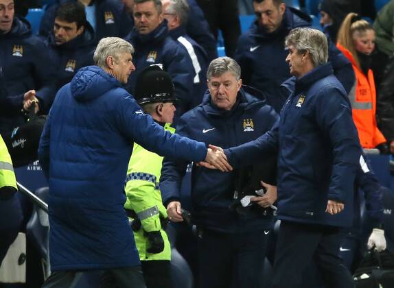Arsene Wenger manager of Arsenal shakes hands with Manuel Pellegrini manager of Manchester City at the end of the match - Barclays Premier League - Manchester City vs Arsenal - Etihad Stadium - Manchester - England - 18th January 2015 - Picture Simon Bellis Sportimage EDITORIAL USE ONLY. No use with unauthorised audio, video, data, fixture lists, club league logos or live services. Online in-match use limited to 120 images, no video emulation. No use in betting, games or single club league player publications.