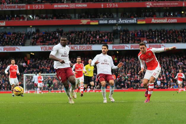 Arsenal s Mesut Ozil scoring his sides second goal Barclays Premier League - Arsenal vs Aston Villa - Emirates Stadium - England - 1st February 2015 - Picture David Klein Sportimage EDITORIAL USE ONLY. No use with unauthorised audio, video, data, fixture lists, club league logos or live services. Online in-match use limited to 120 images, no video emulation. No use in betting, games or single club league player publications.