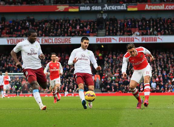 Arsenal s Mesut Ozil scoring his sides second goal Barclays Premier League - Arsenal vs Aston Villa - Emirates Stadium - England - 1st February 2015 - Picture David Klein Sportimage EDITORIAL USE ONLY. No use with unauthorised audio, video, data, fixture lists, club league logos or live services. Online in-match use limited to 120 images, no video emulation. No use in betting, games or single club league player publications.