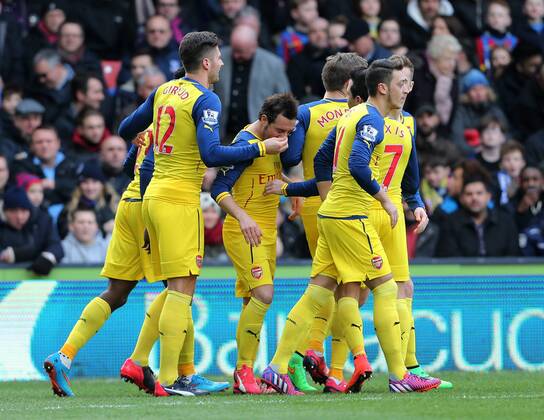 Arsenal s Santi Cazorla celebrates scoring his sides opening goal as Olivier Giroud holds his nose Barclays Premier League - Crystal Palace vs Arsenal - Selhurst Park - England - 21st February 2015 - Picture David Klein Sportimage EDITORIAL USE ONLY. No use with unauthorised audio, video, data, fixture lists, club league logos or live services. Online in-match use limited to 120 images, no video emulation. No use in betting, games or single club league player publications.
