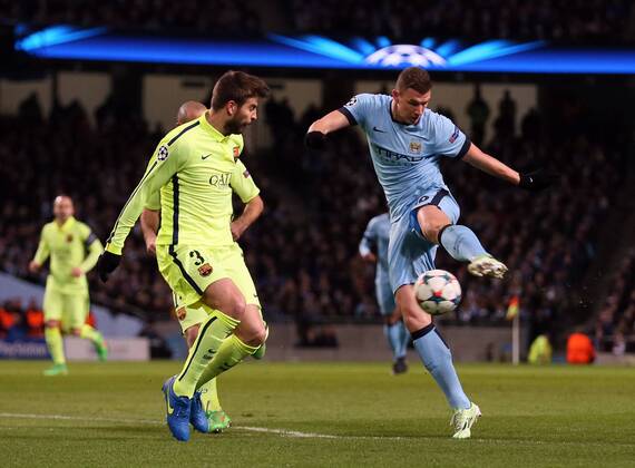 Edin Dzeko of Manchester City takes a shot on goal which is blocked by Gerard Pique of Barcelona - UEFA Champions League last-16 First Leg - Manchester City vs Barcelona - Etihad Stadium - Manchester - England - 24th February 2015 - Picture Simon Bellis Sportimage EDITORIAL USE ONLY. No use with unauthorised audio, video, data, fixture lists, club league logos or live services. Online in-match use limited to 120 images, no video emulation. No use in betting, games or single club league player publications.