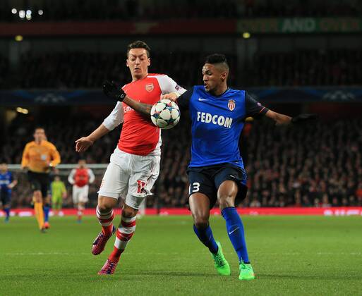 Arsenal s Mesut Ozil tussles with Monaco s Wallace who appears to handle the ball but no penalty is given Champions League - Arsenal vs AS Monaco - Emirates Stadium - England - 25th February 2015 - Picture David Klein Sportimage EDITORIAL USE ONLY. No use with unauthorised audio, video, data, fixture lists, club league logos or live services. Online in-match use limited to 120 images, no video emulation. No use in betting, games or single club league player publications.