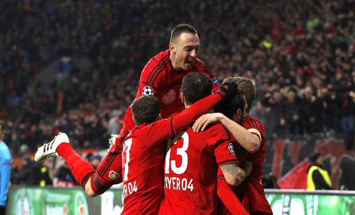 Leverkusens Hakan Calhanoglu (M) celebrates scoring the 1:0 with Leverkusens Lars Bender (R) and Leverkusens Josip Drmic (L) during the Championsleague between Bayer 04 Leverkusen and Atletico Madrid, Bayarena in Leverkusen on February 25., 2015. Bayer 04 Leverkusen vs. Atletico Madrid im Achtelfinale der Champions League der Saison 2014 2015 am 25. Februar 2015.