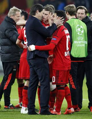 Leverkusens head coach Roger Schmidt (L) and Leverkusens Hakan Calhanoglu celebrate the vitory during the Championsleague between Bayer 04 Leverkusen and Atletico Madrid, Bayarena in Leverkusen on February 25., 2015. Bayer 04 Leverkusen vs. Atletico Madrid im Achtelfinale der Champions League der Saison 2014 2015 am 25. Februar 2015.