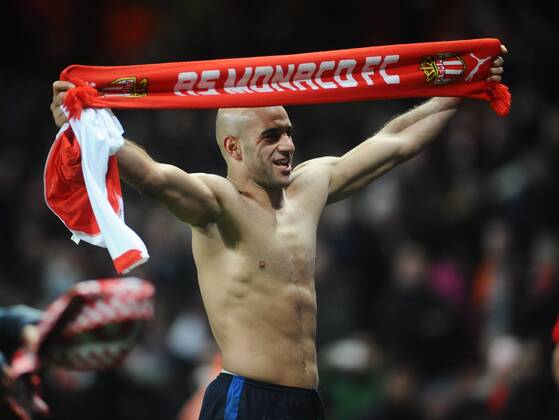 Football - 2014 2015 Champions League - Round of 16, First Leg: Arsenal vs. AS Monaco Aymen Abdennour of Monaco celebrates after the match with a Monaco Scarf at The Emirates. COLORSPORT ANDREW COWIE 