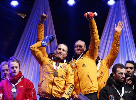 BIATHLON - IBU WC Kontiolahti 2015 KONTIOLAHTI,FINLAND,14.MAR.15 - BIATHLON - IBU World Championships, relay 4x7,5km, men, Medal Plaza, award ceremony. Image shows Erik Lesser and Daniel Böhm (GER).