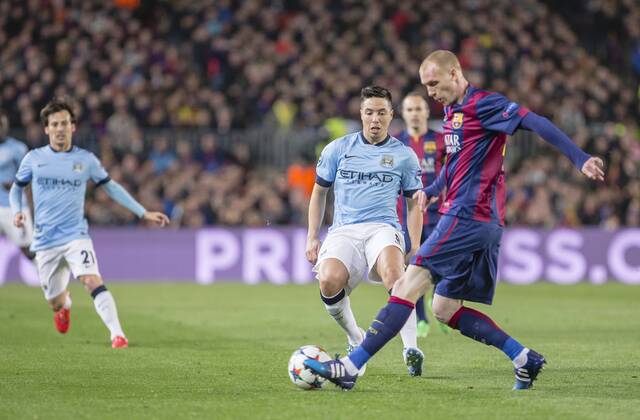 BARCELONA, SPAIN - MARCH 18: Jeremy Mathieu of FC Barcelona Barca and Samir Nasri of Manchester City during the UEFA Champions League round of 16 match between FC Barcelona and Manchester City at Camp Nou Stadium on March 18, 2015 in Barcelona, Spain. 