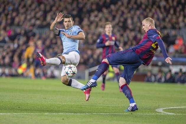 BARCELONA, SPAIN - MARCH 18: Jeremy Mathieu of FC Barcelona Barca and Sergio Kun Agüero of Manchester City during the UEFA Champions League round of 16 match between FC Barcelona and Manchester City at Camp Nou Stadium on March 18, 2015 in Barcelona, Spain. 