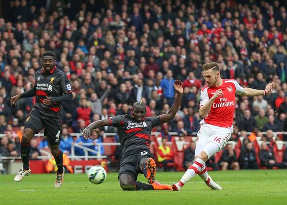 Football - 2014 2015 - Barclays Premier League, - Arsenal Vs Liverpool, Arsenal s Aaron Ramsey slides the ball past Liverpool s Mamadou Sakho at The Emirates Stadium COLORSPORT DANIEL BEARHAM ARS_LIV