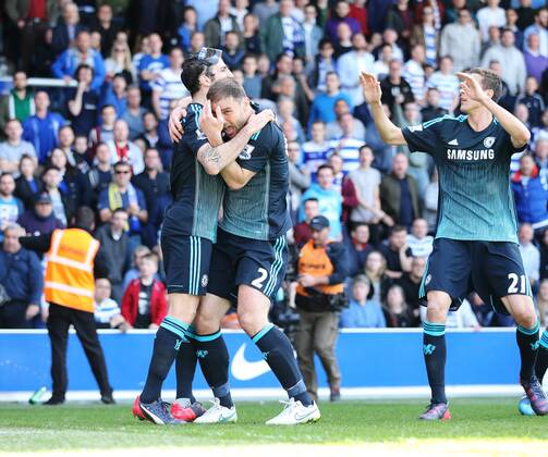 Chelsea s Cesc Fabregas celebrates scoring his sides opening goal as Branislav Ivanovic gets hit by a coin Barclays Premier League- Queens Park Rangers vs Chelsea - Loftus Road - England - 12h April 2015 - Picture David Klein Sportimage EDITORIAL USE ONLY. No use with unauthorised audio, video, data, fixture lists, club league logos or live services. Online in-match use limited to 120 images, no video emulation. No use in betting, games or single club league player publications.