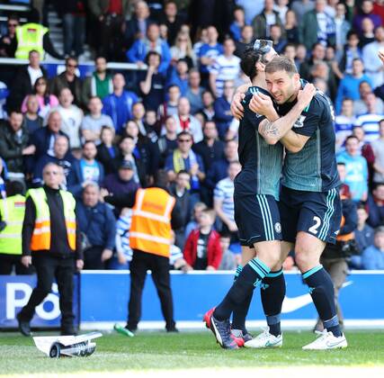 Chelsea s Cesc Fabregas celebrates scoring his sides opening goal as Branislav Ivanovic gets hit by a coin Barclays Premier League- Queens Park Rangers vs Chelsea - Loftus Road - England - 12h April 2015 - Picture David Klein Sportimage EDITORIAL USE ONLY. No use with unauthorised audio, video, data, fixture lists, club league logos or live services. Online in-match use limited to 120 images, no video emulation. No use in betting, games or single club league player publications.