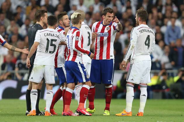 Mario Mandzukic of Atletico has words with Sergio Ramos of Real Madrid - Real Madrid vs. Atletico Madrid - UEFA Champions League - Quarter Final Second Leg - Santiago Bernabeu - Madrid - 22 04 2015 Pic Philip Oldham Sportimage EDITORIAL USE ONLY. No use with unauthorised audio, video, data, fixture lists, club league logos or live services. Online in-match use limited to 120 images, no video emulation. No use in betting, games or single club league player publications.