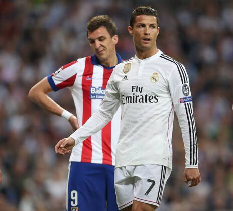Mario Mandzukic of Atletico looks dejected alongside Cristiano Ronaldo of Real Madrid - Real Madrid vs. Atletico Madrid - UEFA Champions League - Quarter Final Second Leg - Santiago Bernabeu - Madrid - 22 04 2015 EDITORIAL USE ONLY. No use with unauthorised audio, video, data, fixture lists, club league logos or live services. Online in-match use limited to 120 images, no video emulation. No use in betting, games or single club league player publications.