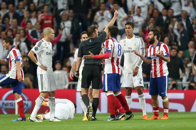 Arda Turan of Atletico is shown a red card for his second yellow offence - Real Madrid vs. Atletico Madrid - UEFA Champions League - Quarter Final Second Leg - Santiago Bernabeu - Madrid - 22 04 2015 Pic Philip Oldham Sportimage EDITORIAL USE ONLY. No use with unauthorised audio, video, data, fixture lists, club league logos or live services. Online in-match use limited to 120 images, no video emulation. No use in betting, games or single club league player publications.