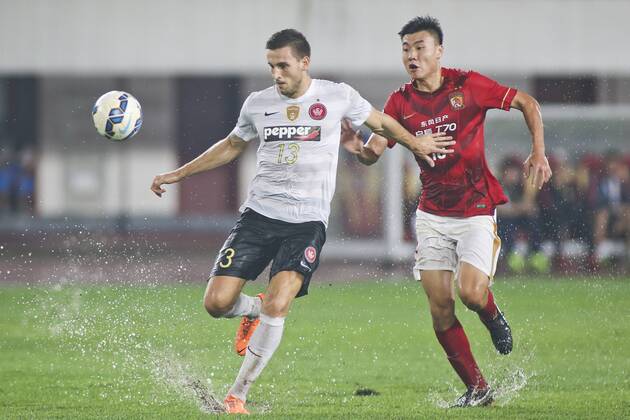 GUANGZHOU, CHINA - MAY 05: (CHINA OUT) Dong Xuesheng 18 of Guangzhou Evergrande and Matthew Spiranovic 13 of Western Sydney Wanderers compete for the ball during the AFC Asian Champions League Group H match between Guangzhou Evergrande and Western Sydney Wanderers at Tianhe Sports Center on May 5, 2015 in Guangzhou, China.  CFP467029053 