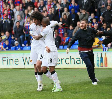 Manchester United ManU s Marouane Fellaini celebrates scoring his sides second goal as fans invade the pitch Barclays Premier League - Crystal Palace vs Manchester United- Selhurst Park - England - 9th May 2015 - Picture David Klein Sportimage EDITORIAL USE ONLY. No use with unauthorised audio, video, data, fixture lists, club league logos or live services. Online in-match use limited to 120 images, no video emulation. No use in betting, games or single club league player publications.