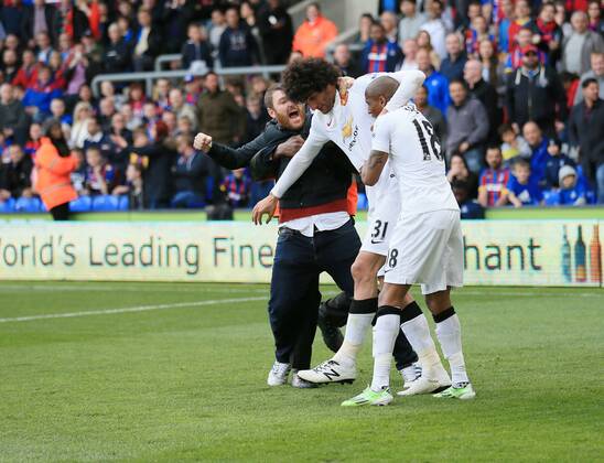 Manchester United ManU s Marouane Fellaini celebrates scoring his sides second goal as fans invade the pitch Barclays Premier League - Crystal Palace vs Manchester United- Selhurst Park - England - 9th May 2015 - Picture David Klein Sportimage EDITORIAL USE ONLY. No use with unauthorised audio, video, data, fixture lists, club league logos or live services. Online in-match use limited to 120 images, no video emulation. No use in betting, games or single club league player publications.