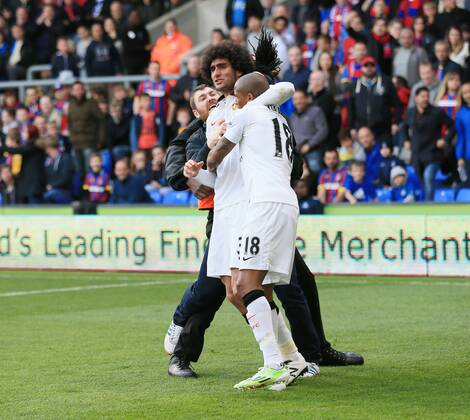 Manchester United ManU s Marouane Fellaini celebrates scoring his sides second goal as fans invade the pitch Barclays Premier League - Crystal Palace vs Manchester United- Selhurst Park - England - 9th May 2015 - Picture David Klein Sportimage EDITORIAL USE ONLY. No use with unauthorised audio, video, data, fixture lists, club league logos or live services. Online in-match use limited to 120 images, no video emulation. No use in betting, games or single club league player publications.