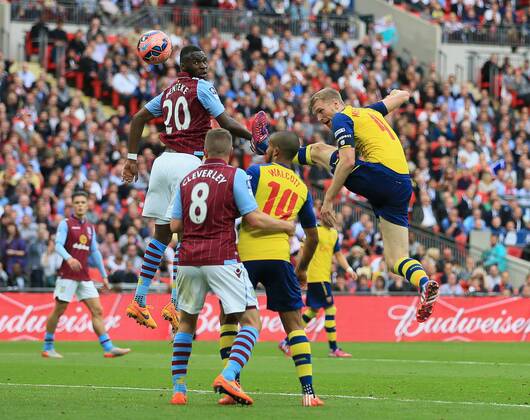 Arsenal s Per Mertesacker scoring his sides third goal FA Cup Final - Arsenal vs Aston Villa - Wembley Stadium - England - 30th May 2015 - Picture David Klein Sportimage EDITORIAL USE ONLY. No use with unauthorised audio, video, data, fixture lists, club league logos or live services. Online in-match use limited to 120 images, no video emulation. No use in betting, games or single club league player publications.