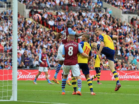 Arsenal s Per Mertesacker scoring his sides third goal FA Cup Final - Arsenal vs Aston Villa - Wembley Stadium - England - 30th May 2015 - Picture David Klein Sportimage EDITORIAL USE ONLY. No use with unauthorised audio, video, data, fixture lists, club league logos or live services. Online in-match use limited to 120 images, no video emulation. No use in betting, games or single club league player publications.