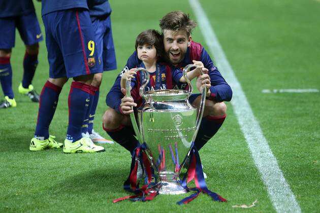Gerard Pique of Barcelona poses with the trophy and his son - Juventus vs. Barcelona - Champion s League Final - Olympic Stadium - Berlin - Germany - 06 06 2015 Pic Philip Oldham Sportimage EDITORIAL USE ONLY. No use with unauthorised audio, video, data, fixture lists, club league logos or live services. Online in-match use limited to 120 images, no video emulation. No use in betting, games or single club league player publications.