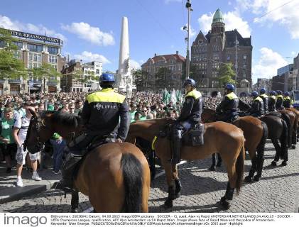 SOCCER - CL quali, Ajax vs Rapid AMSTERDAM,NETHERLANDS,04.AUG.15 - SOCCER - UEFA Champions League, qualification, AFC Ajax Amsterdam vs SK Rapid Wien. Image shows fans of Rapid Wien and the police of Amsterdam. Keywords: Wien Energie. GEPAxpictures xM.xHoermandinger