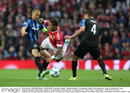 Memphis Depay of Manchester United ManU goes down under a challenge by Oscar Duarte of Brugge - Manchester United vs. Club Brugge - UEFA Champion s League Play Off - Old Trafford - Manchester - 18 08 2015 Pic Philip Oldham SportImage EDITORIAL USE ONLY. No use with unauthorised audio, video, data, fixture lists, club league logos or live services. Online in-match use limited to 120 images, no video emulation. No use in betting, games or single club league player publications.