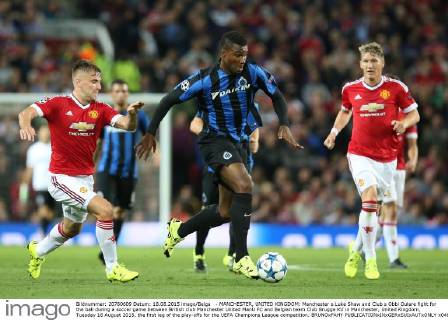 - MANCHESTER, UNITED KINGDOM: Manchester s Luke Shaw and Club s Obbi Oulare fight for the ball during a soccer game between British club Manchester United ManU FC and Belgian team Club Brugge KV in Manchester, United Kingdom, Tuesday 18 August 2015, the first leg of the play-offs for the UEFA Champions League competition. BRUNOxFAHY  x04682744x