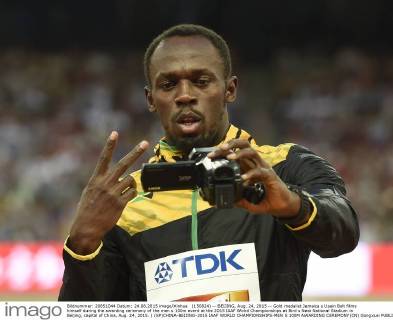 (150824) -- BEIJING, Aug. 24, 2015 -- Gold medalist Jamaica s Usain Bolt films himself during the awarding ceremony of the men s 100m event at the 2015 IAAF Wolrd Championships at Bird s Nest National Stadium in Beijing, capital of China, Aug. 24, 2015. ) (SP)CHINA-BEIJING-2015 IAAF WORLD CHAMPIONSHIPS-MEN S 100M AWARDING CEREMONY(CN) GongxLei 