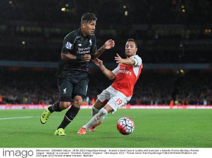 Arsenal s Santi Cazorla tussles with Liverpool s Roberto Firmino Barclays Premier League - Arsenal vs Liverpool - Emirates Stadium -England - 24th August 2015 - Picture David Klein Sportimage EDITORIAL USE ONLY. No use with unauthorised audio, video, data, fixture lists, club league logos or live services. Online in-match use limited to 120 images, no video emulation. No use in betting, games or single club league player publications.